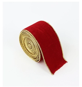 Macro detail of red velvet Christmas ribbon with golden metallic wire edges in a roll