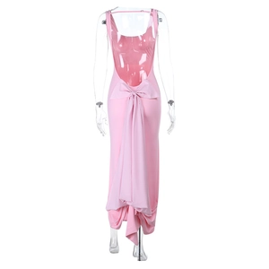 Detailed back view of pink backless dress featuring a large bow and long ribbons