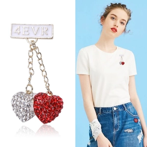 Dual-tone heart brooch with 4EVR bar and rhinestones shown on model and white background