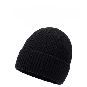 Close-up of black ribbed knit beanie with soft texture and small branded tag detail