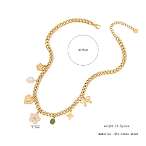 Detail showing gold stainless steel necklace charms with flower, heart and emerald gem