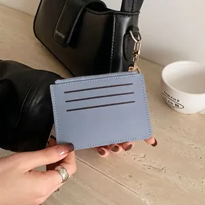 Slim light blue leather card holder with three slots and a gold keychain hook