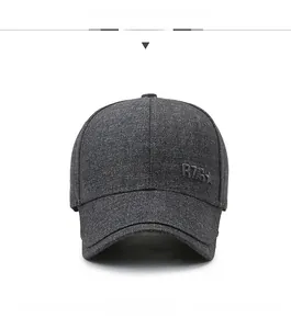 Detailed texture of dark grey fabric baseball cap with embossed star logo and curved brim
