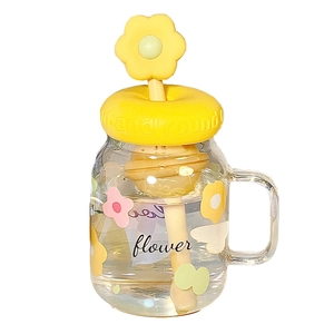 Clear glass mason jar with handle yellow floral lid and colorful flower patterns