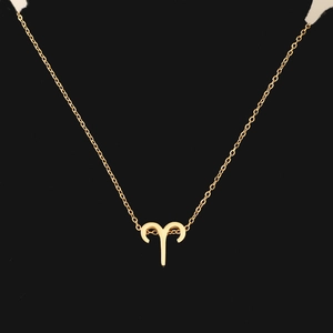 Detailed close-up of a gold Aries zodiac pendant necklace on a sleek black background