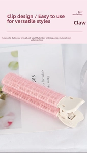 Detailed close-up of pink hair root volumizing clip with professional spring mechanism