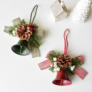 Red and green Christmas bell ornaments with pine cones and berries for tree decoration