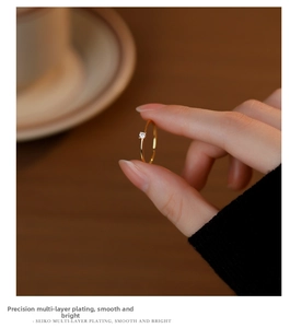 Detailed view of gold S925 silver ring featuring a sparkling white zircon on a slim band