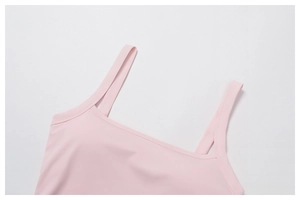 Detailed close-up of light pink yoga top featuring square neckline and double straps