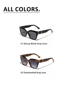 Detail of cat eye sunglasses in glossy black and tortoise shell frames with metal accents
