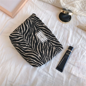 Detail of zebra pattern woven fabric bag with Time to Party label on cotton texture