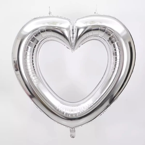 Detail of 40-inch silver hollow heart foil balloon with glossy metallic finish for parties