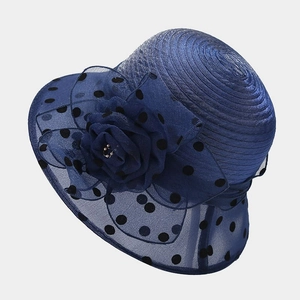 Close-up of navy organza sun hat featuring delicate mesh flowers and black polka dot brim