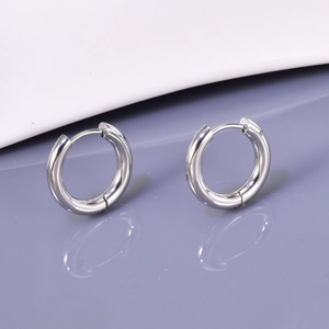 Close-up of polished silver stainless steel hoop earrings with secure click clasp closure