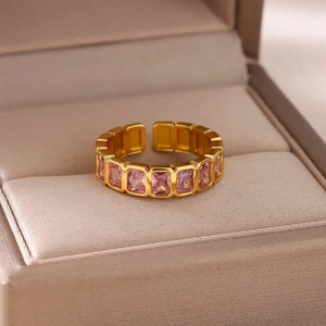 Detailed macro view of gold adjustable ring featuring pink rectangular zircon stones