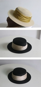 Detailed view of woven straw sun hats with elegant pleated satin ribbons in various colors