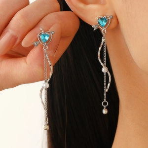 Elegant Cupid's heart earrings featuring blue gemstones, white pearls and silver tassels