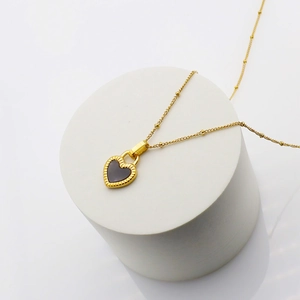 Elegant 18K gold plated heart pendant necklace with black enamel and beaded chain detail