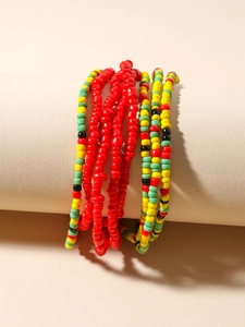 Detailed close-up of multilayered bohemian colorful seed bead chains on a cylindrical display