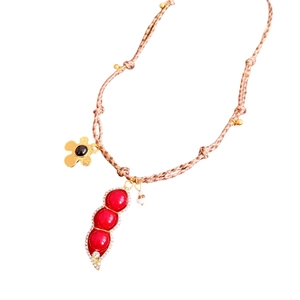 Vintage necklace with red pea pod pendant, zircon accents, and woven cord chain