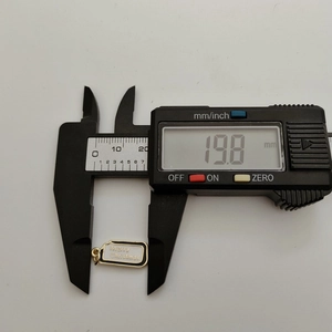 Detail shot of Christmas pendant showing 19.8mm length measurement on digital caliper