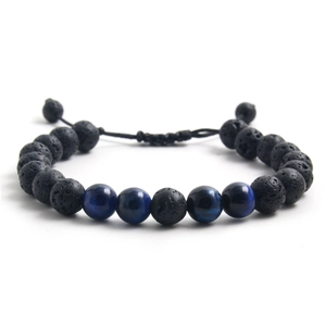 Macro detail of 8mm lava rock beads and blue tiger eye stone with adjustable cord