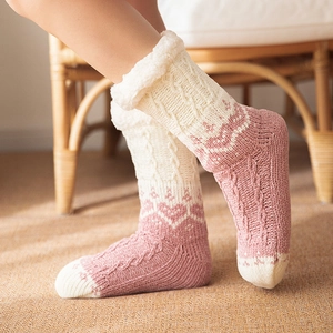 Pink knit winter slipper socks with thick white faux fur trim and cable knit pattern