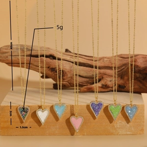Colorful mosaic heart necklaces with gold chains and micro-inlaid rhinestones on sandstone