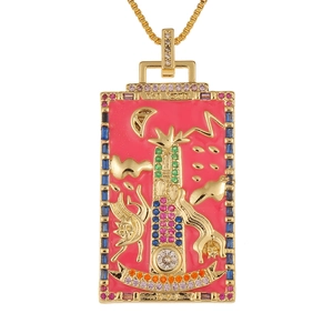 Macro shot of The Tower tarot pendant featuring pink enamel and colorful gemstones on gold frame