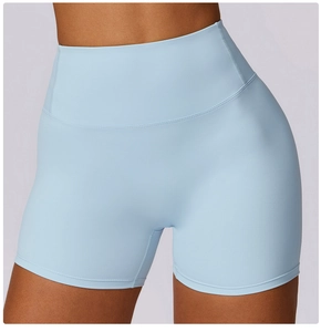 Detail of high-waisted light blue yoga shorts with seamless stitching and matte finish