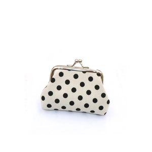 Detailed view of canvas coin purse with black polka dots and silver metal kiss lock