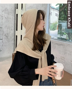 Detail of hooded knit shawl scarf in shell khaki beige for cozy autumn winter style