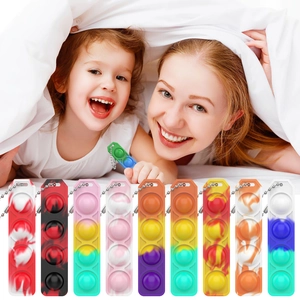 Detail view of colorful silicone Pop It keychains in various marble and macaron color patterns