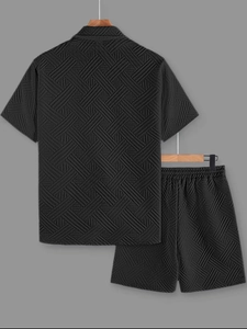 Detail view of black men's summer set showing geometric textured jacquard fabric texture