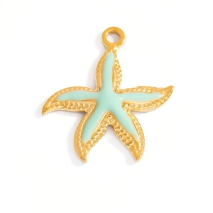 Macro detail of starfish pendant with gold plating and light green enamel finish
