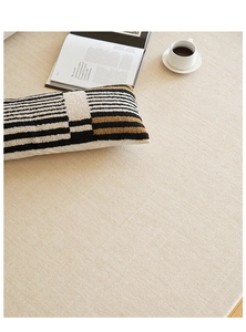 Detailed view of beige woven carpet texture with natural lighting and cozy decor