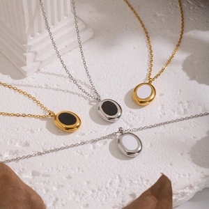 Classic gold and silver oval pendant necklaces with black and white enamel inlays