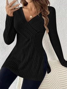 Close-up of black V-neck ribbed long sleeve top featuring detailed side slit design