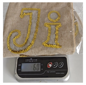 Detail shot of personalized burlap Christmas stocking with gold sequins letter Ji