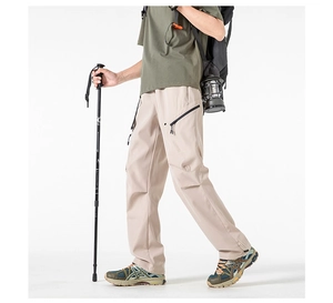 Detail of cargo pants showing side zipper pocket and durable beige ripstop fabric