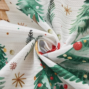 Detail of Christmas curtain fabric with festive tree prints and soft woven texture