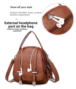 Detail view of a brown pebbled leather mini crossbody bag featuring a metal headphone port