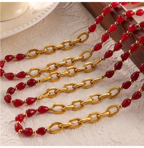 Detail of vintage red agate beads and gold chain necklace with polished finish