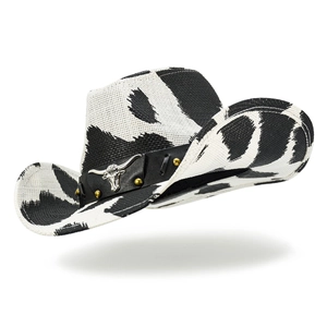Detail of western cow print hat featuring silver bull head buckle and golden studs