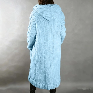Macro detail of chunky cable knit pattern on light blue hooded long cardigan