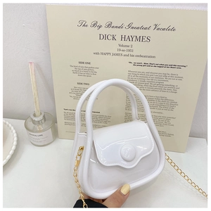 Detailed macro view of a white mini jelly handbag with a golden chain strap