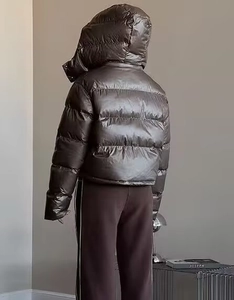 Rear view of dark grey shiny hooded jacket showcasing loose fit and fabric sheen detail