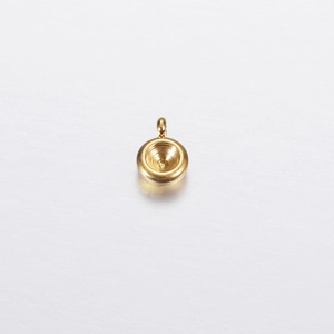 Close-up of golden stainless steel round bezel pendant setting for jewelry making