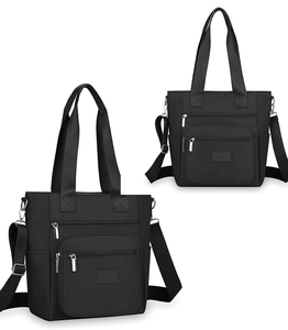 Detail view of black oxford nylon tote with multi-pocket design and silver hardware