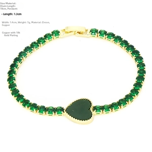 Detail of 18k gold plated tennis bracelet with green heart pendant and round zircons